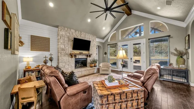 a living room with furniture a fireplace and a flat screen tv