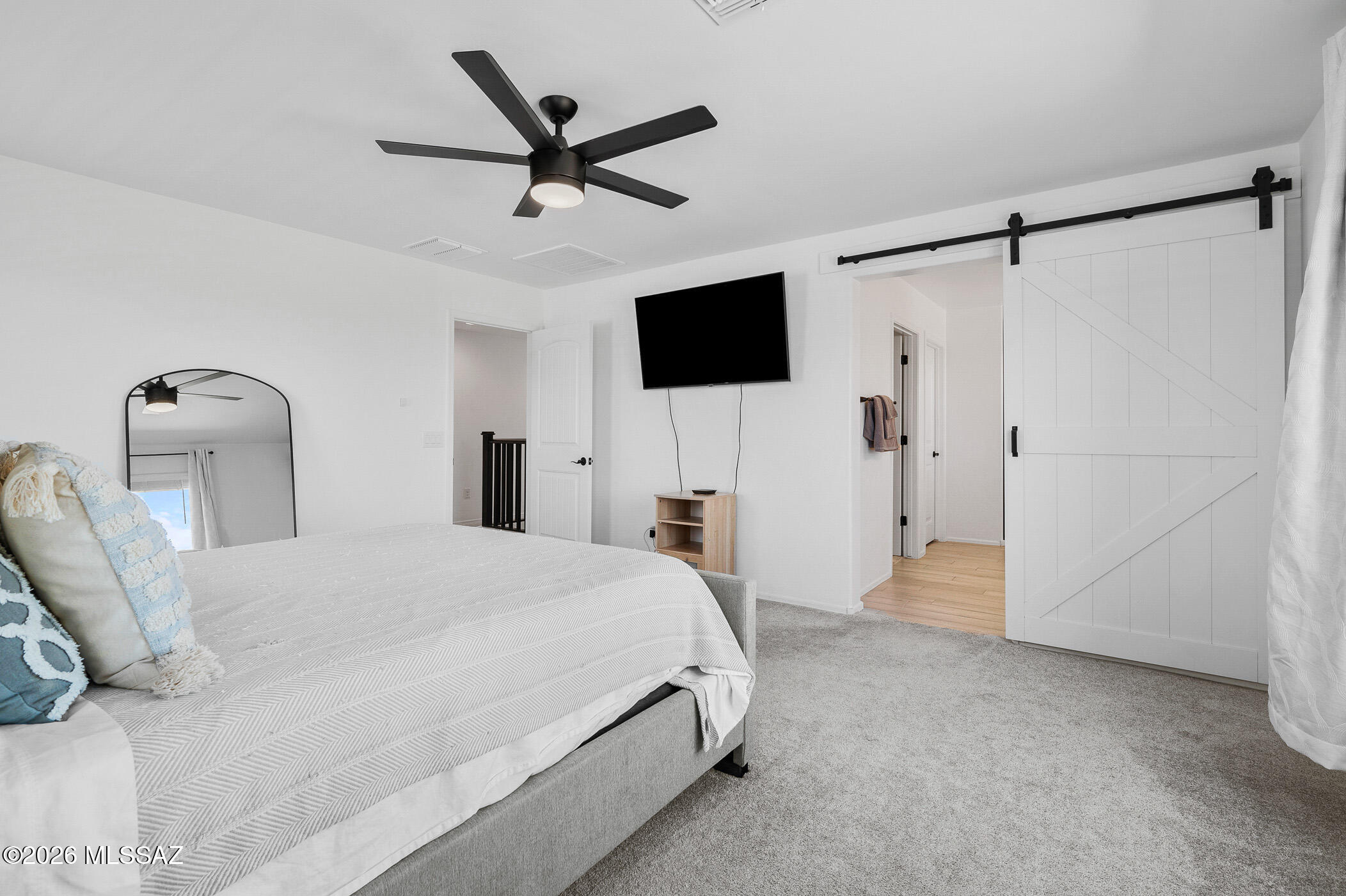 12092 East Ryscott Circle Vail, AZ 85641 - Photo 31 of 49 a bedroom with a bed a flat screen tv and a mirror