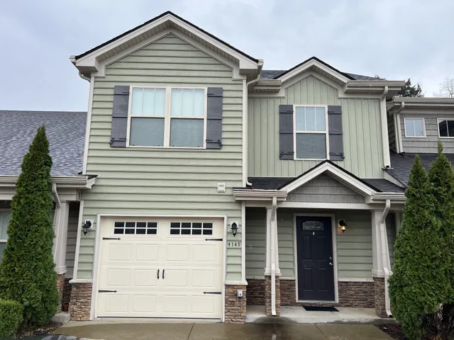 a front view of a house with a garage