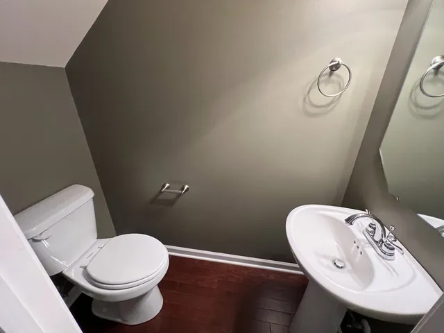 a white toilet sitting next to a bathroom sink