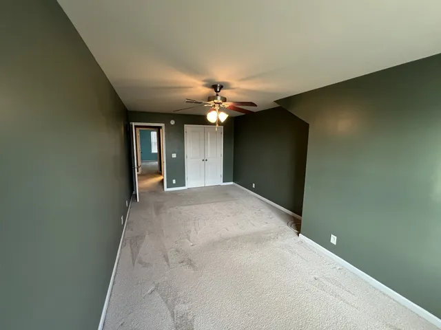a view of a chandelier fan and entryway