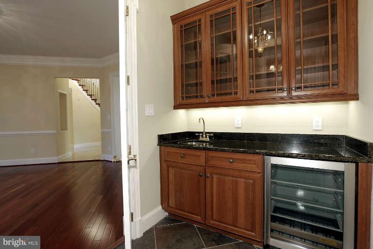 903 Georgetown Ridge Court McLean, VA 22102 - Photo 11 of 29 a kitchen with granite countertop a stove and a microwave oven