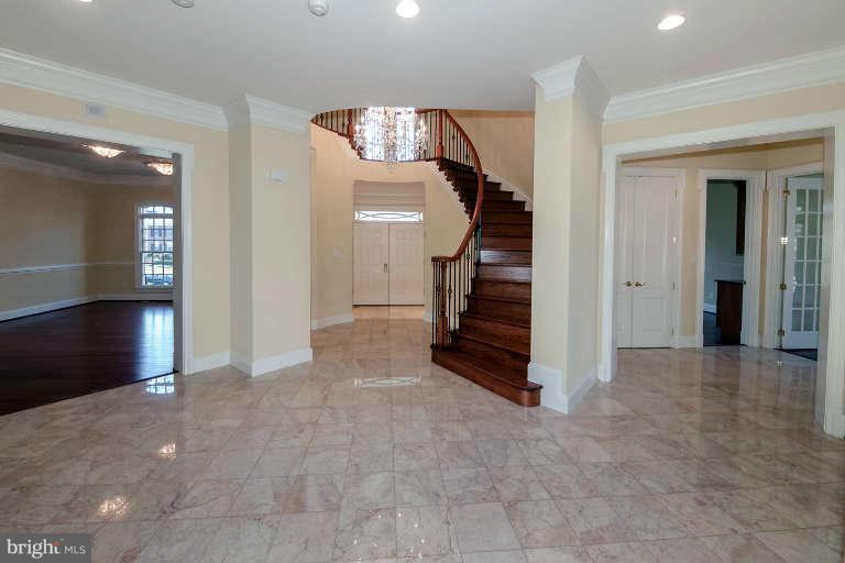 903 Georgetown Ridge Court McLean, VA 22102 - Photo 3 of 29 en view interior of a house with stairs and a living room
