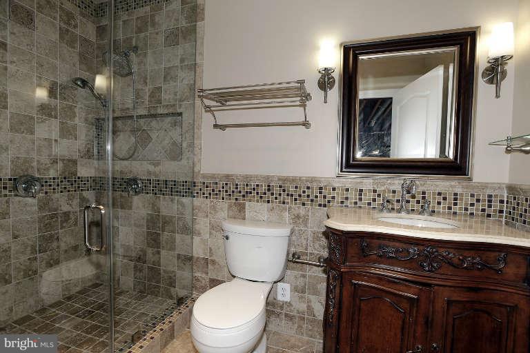 903 Georgetown Ridge Court McLean, VA 22102 - Photo 25 of 29 a bathroom with a toilet sink and mirror