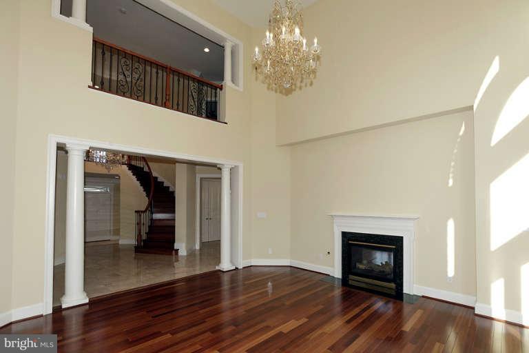 903 Georgetown Ridge Court McLean, VA 22102 - Photo 5 of 29 a view of a livingroom with wooden floor a fireplace and window