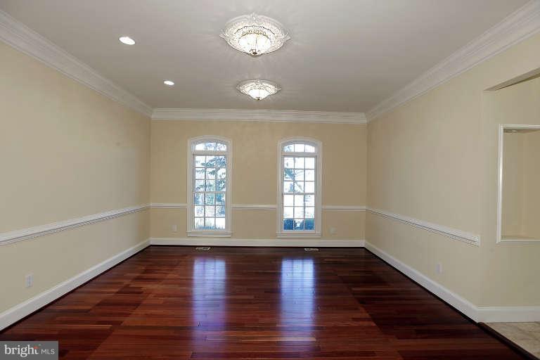 903 Georgetown Ridge Court McLean, VA 22102 - Photo 10 of 29 an empty room with wooden floor and windows