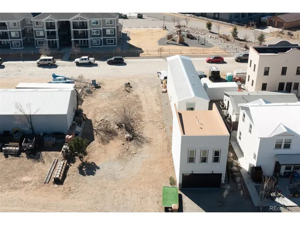 an aerial view of a house with a yard