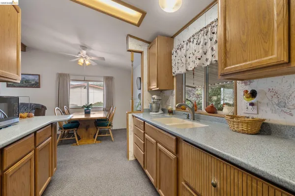 a kitchen with a sink stove and cabinets
