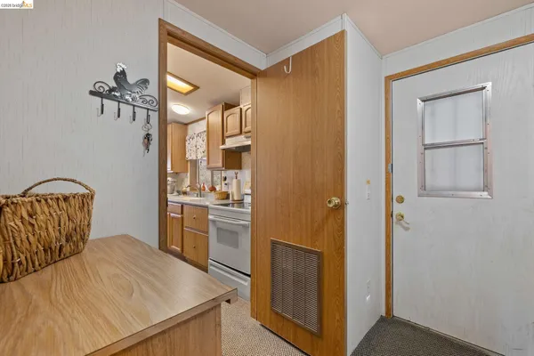 a view of a kitchen from a hallway