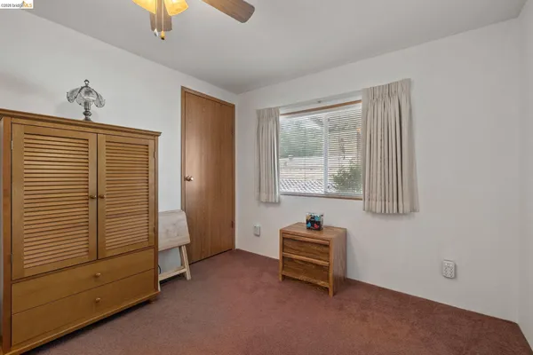 a view of room with window and a ceiling fan