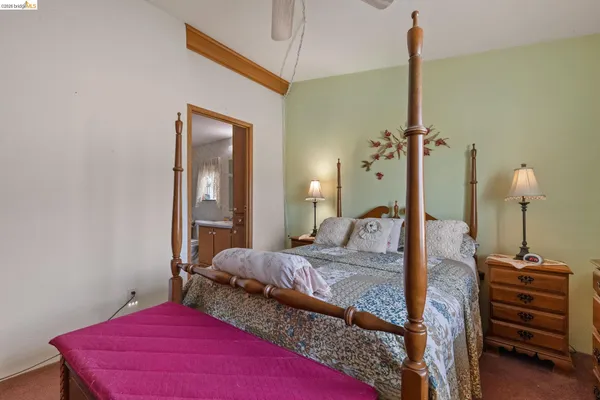 a bedroom with a bed and a mirror