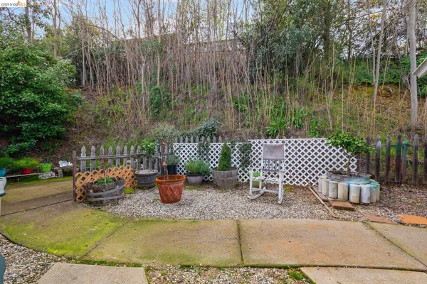 a view of a patio with chairs and plants