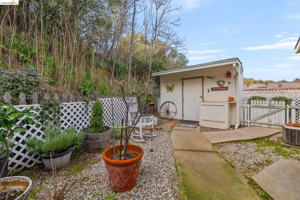 a view of a house with a wooden fence