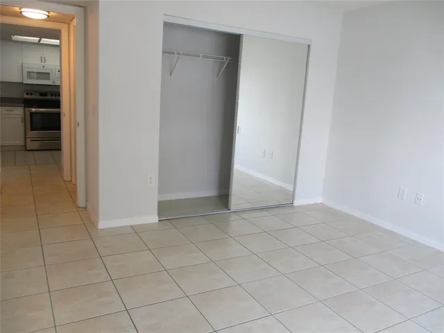 an empty room with kitchen