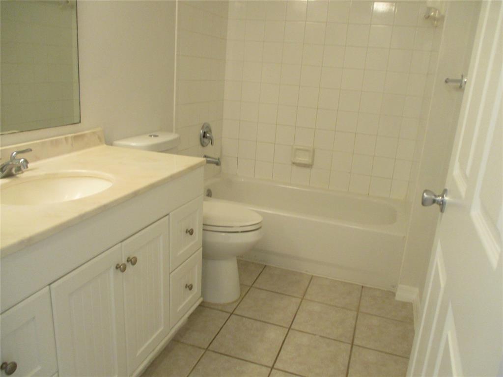 5045 Wiles Road, Unit 206 Coconut Creek, FL 33073 - Photo 16 of 24 a bathroom with a sink a toilet and shower