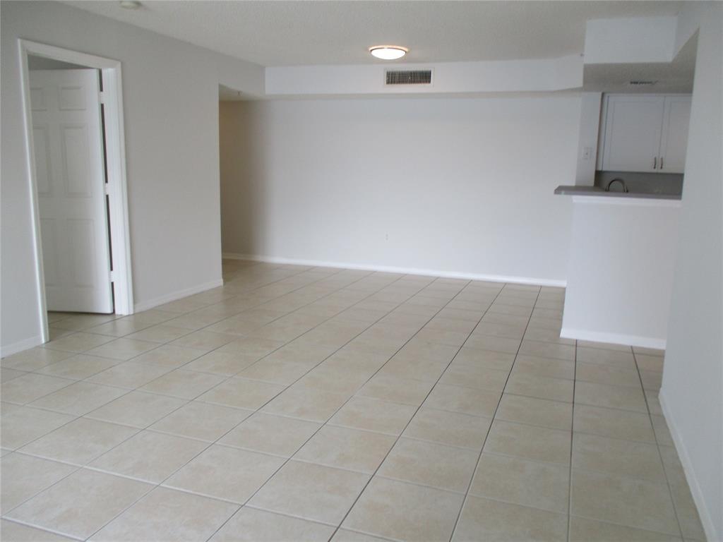 5045 Wiles Road, Unit 206 Coconut Creek, FL 33073 - Photo 8 of 24 a view of an empty room