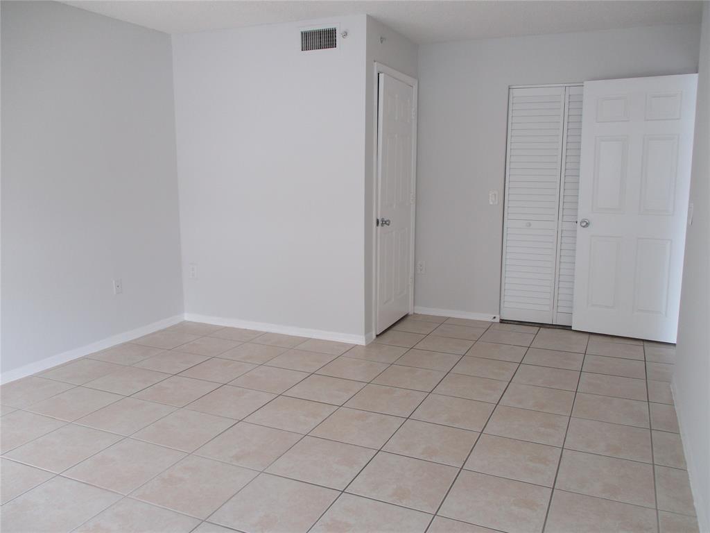 5045 Wiles Road, Unit 206 Coconut Creek, FL 33073 - Photo 10 of 24 an empty room with cabinet