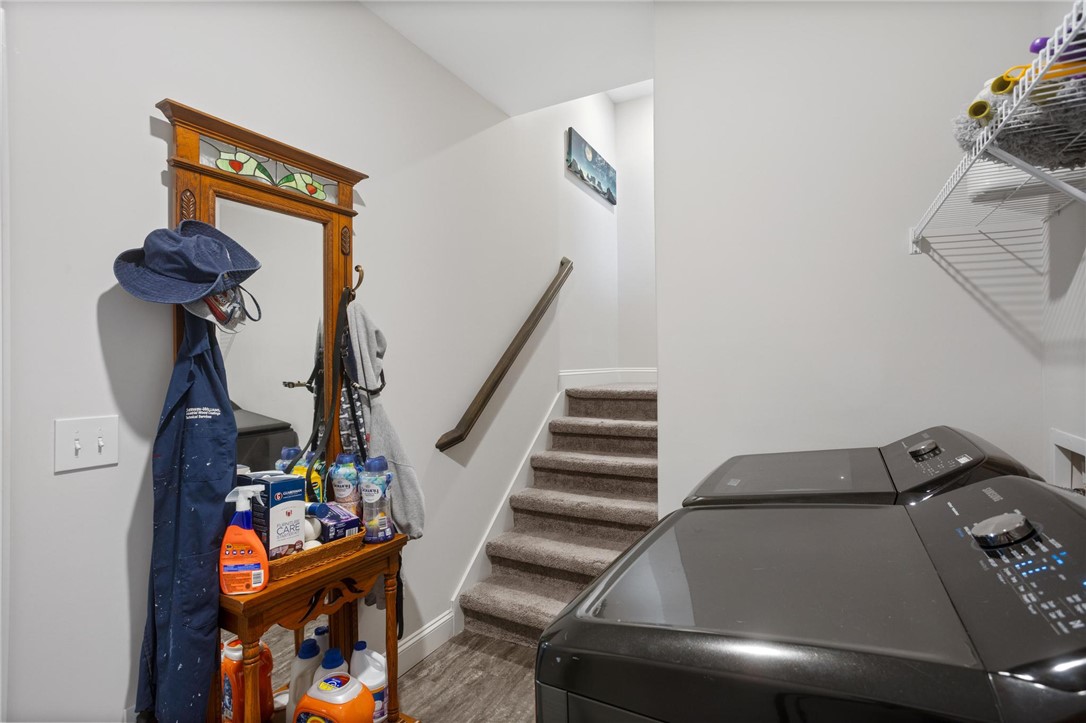 125 Estateside Drive Anderson, SC 29621 - Photo 29 of 37 Functional laundry area featuring modern appliances and a carpeted staircase leading to an upper level.