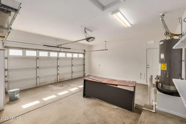 an empty room with chandelier fan