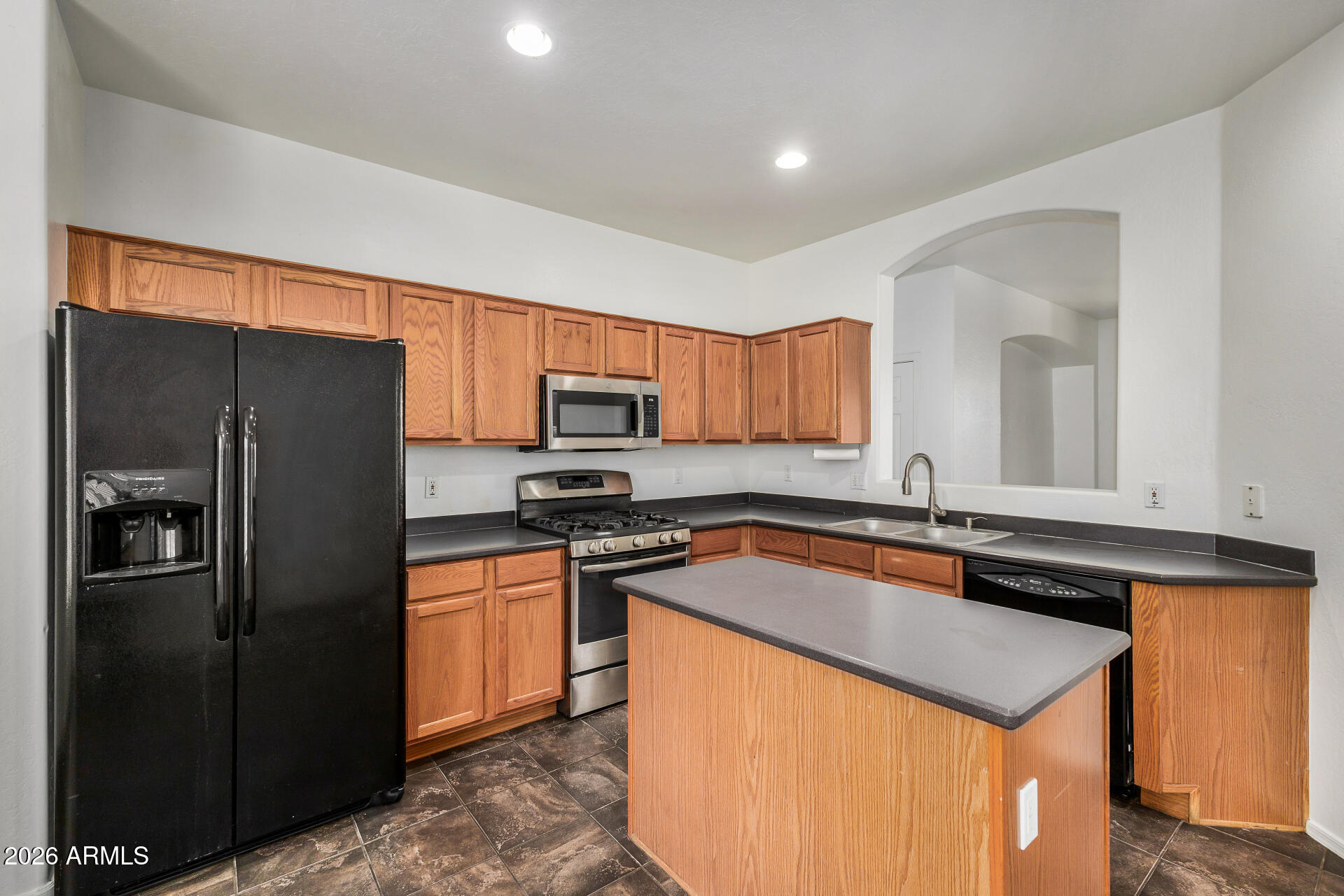 4314 East Megan Street Gilbert, AZ 85295 - Photo 22 of 31 a kitchen with stainless steel appliances granite countertop a refrigerator a sink a stove a microwave and island