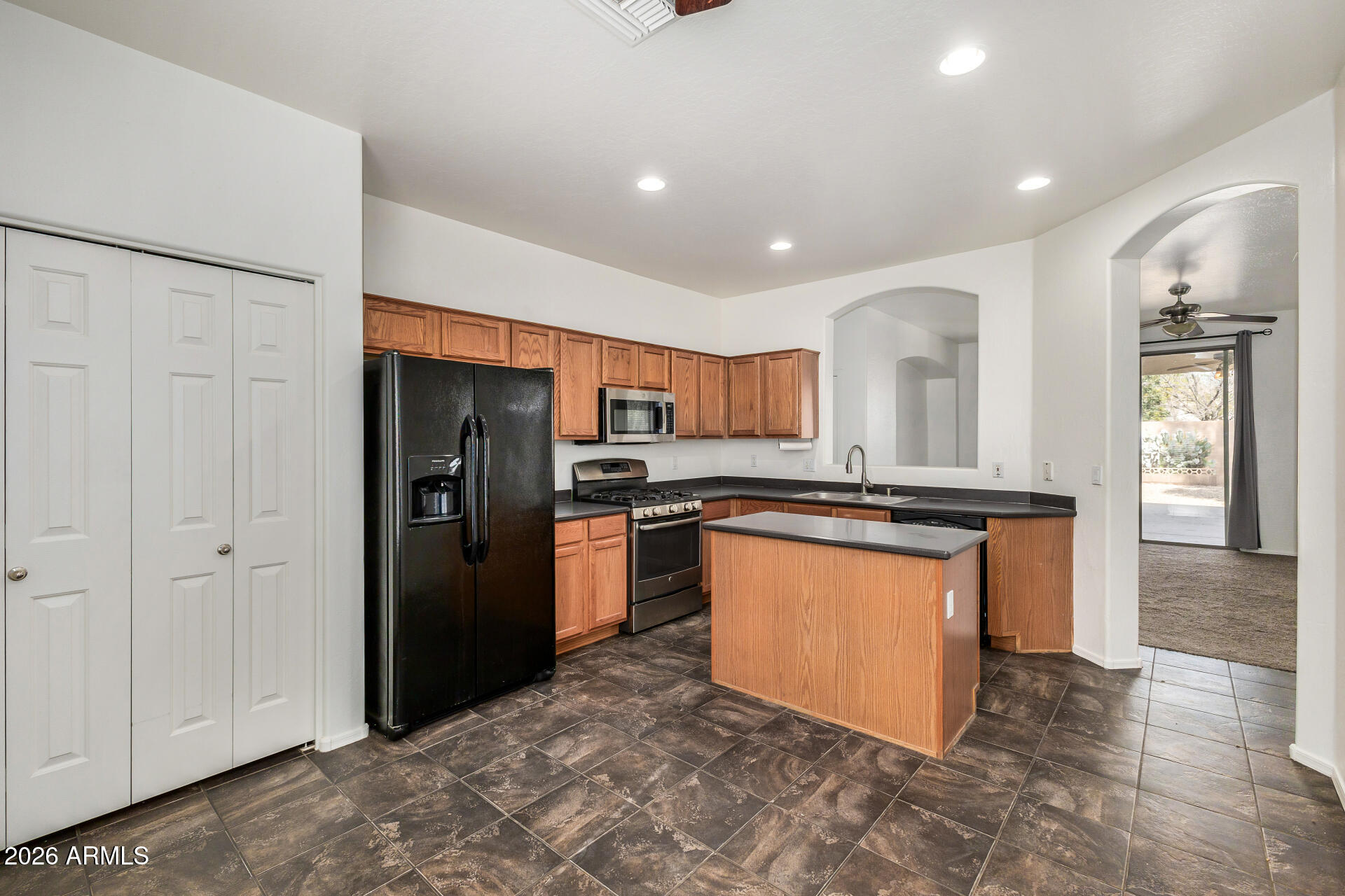 4314 East Megan Street Gilbert, AZ 85295 - Photo 23 of 31 a kitchen with stainless steel appliances granite countertop a refrigerator a sink and a stove