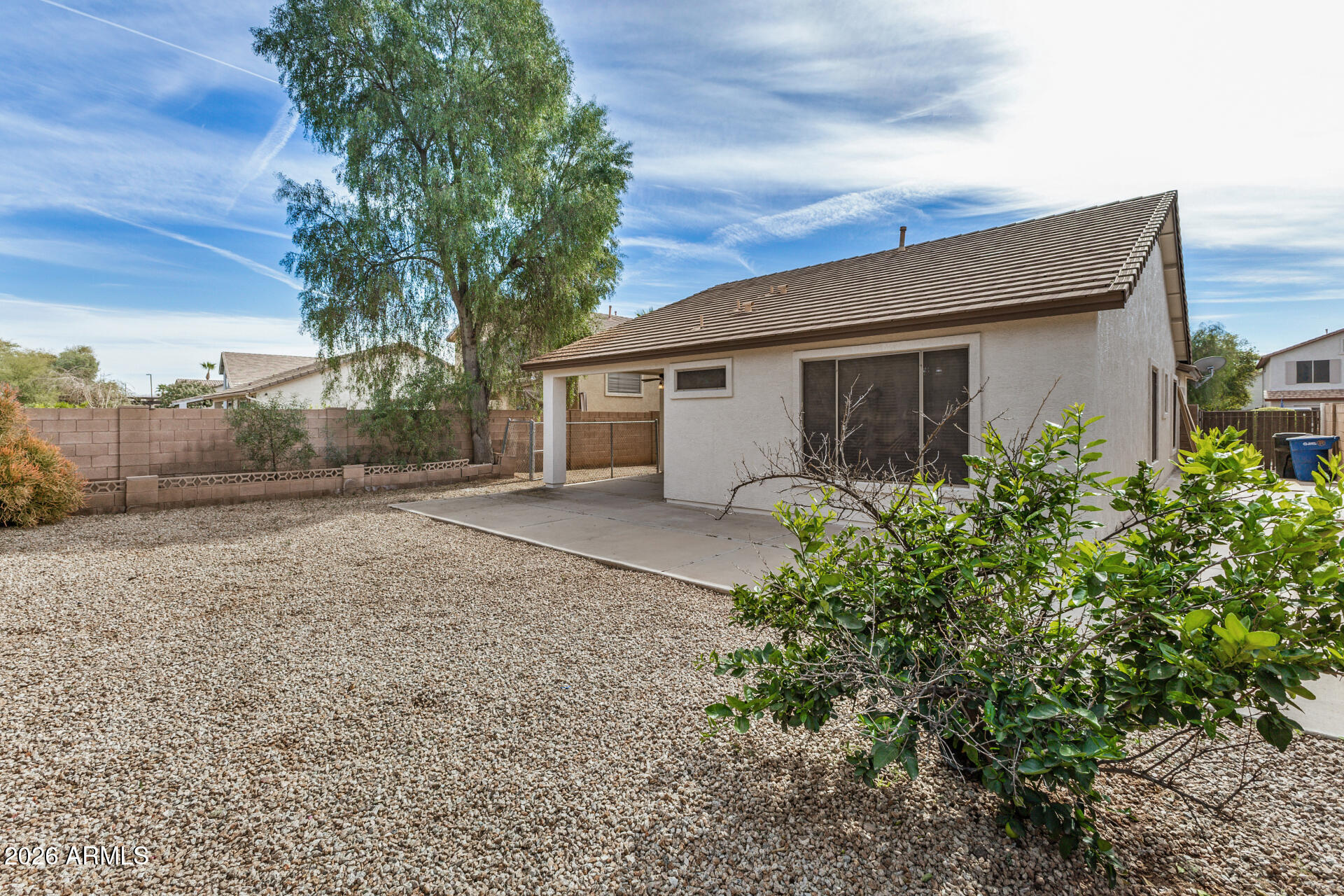4314 East Megan Street Gilbert, AZ 85295 - Photo 3 of 31 a backyard of a house with large trees and garage