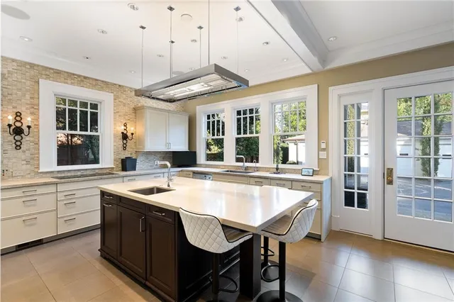 a dining hall with stainless steel appliances granite countertop a stove and a refrigerator