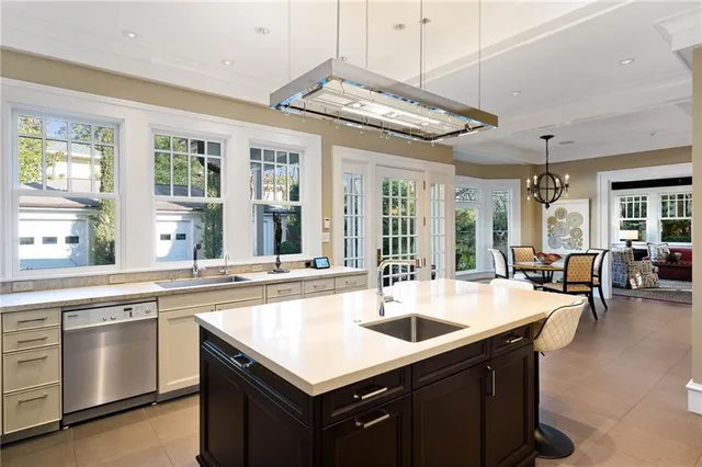 a kitchen with a sink a counter space and stainless steel appliances