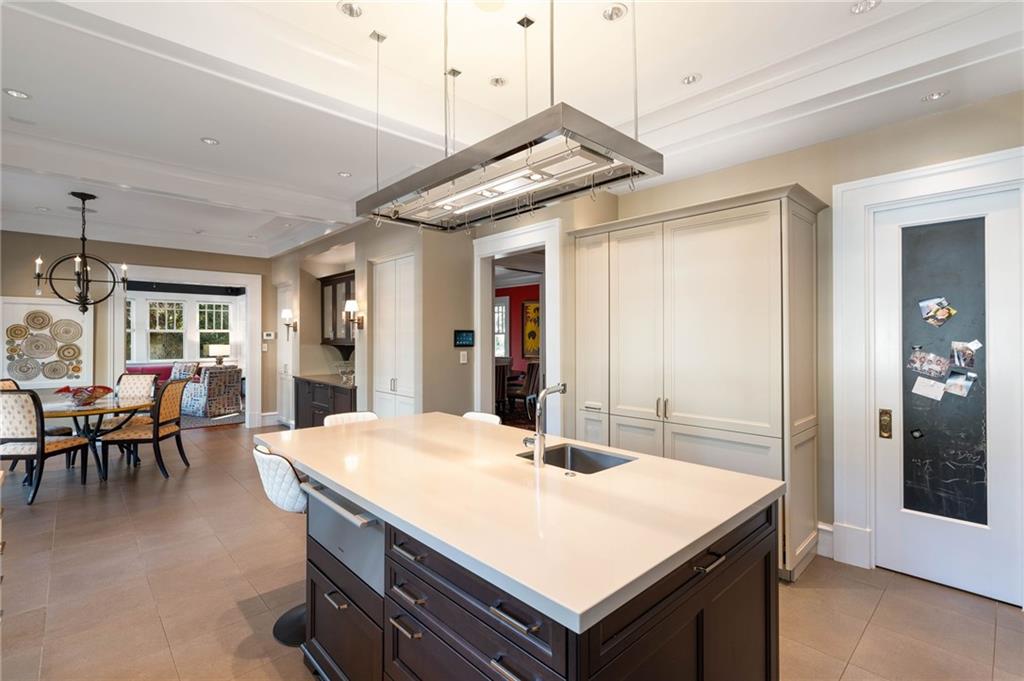 81 Peachtree Circle Northeast Atlanta, GA 30309 - Photo 14 of 54 a kitchen with a table chairs and refrigerator
