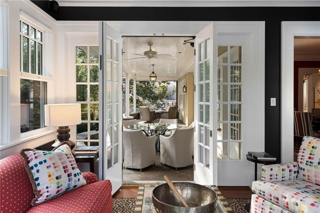 a living room with furniture and a floor to ceiling window