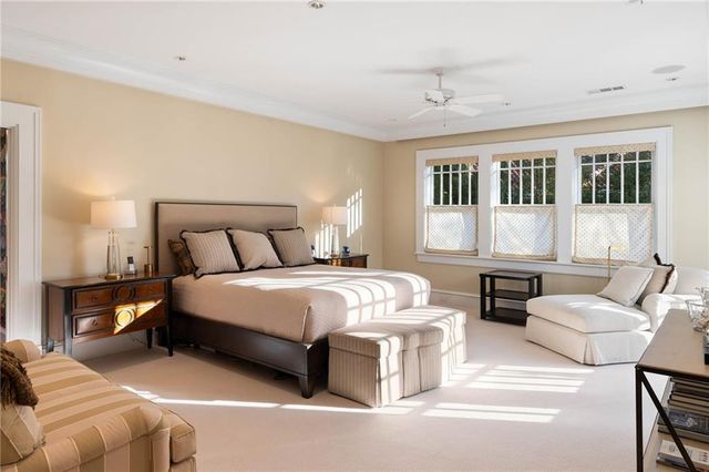 a bedroom with bed couch and window