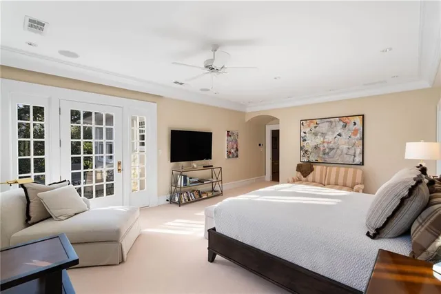 a bedroom with furniture and a flat screen tv