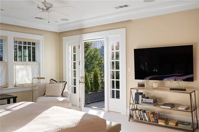 a bedroom with furniture and a flat screen tv