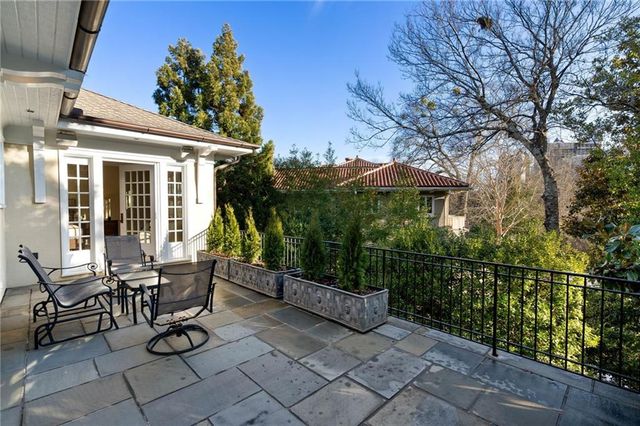 a view of a patio with iron fence