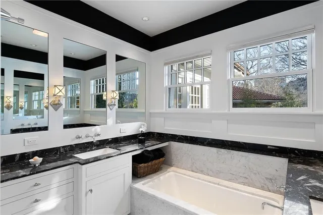 a bedroom with a bed couch and a window