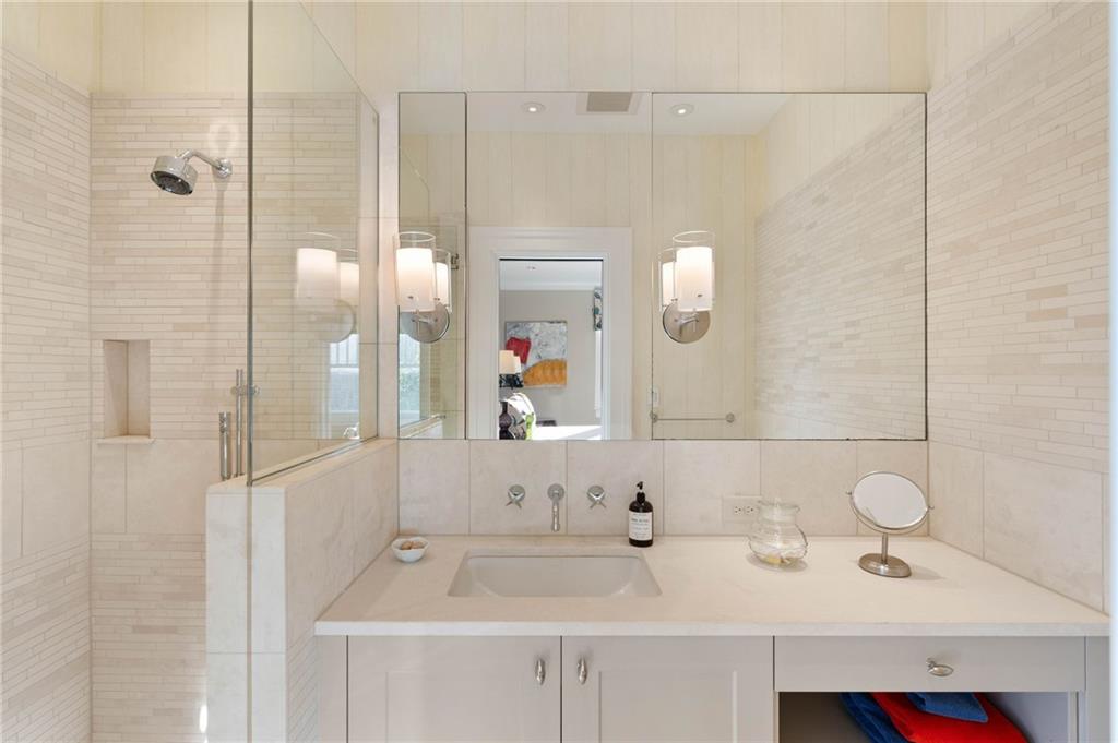 81 Peachtree Circle Northeast Atlanta, GA 30309 - Photo 34 of 54 a bathroom with a sink and a mirror