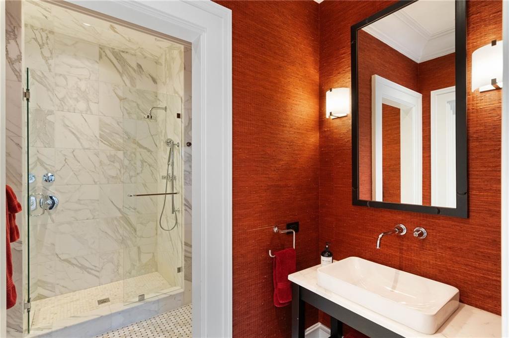 81 Peachtree Circle Northeast Atlanta, GA 30309 - Photo 36 of 54 a bathroom with a sink and a mirror