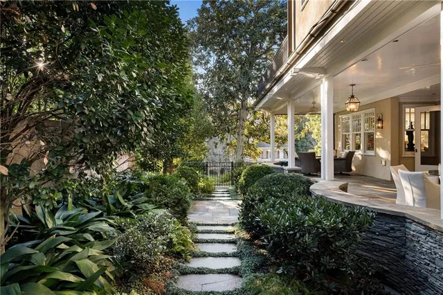 a front view of a house with a garden