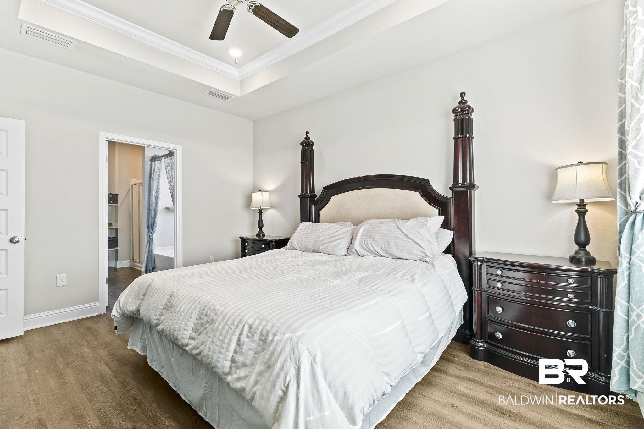 31610 Memphis Loop Daphne, AL 36527 - Photo 21 of 67 Bedroom featuring visible vents, ornamental molding, a raised ceiling, and wood finished floors