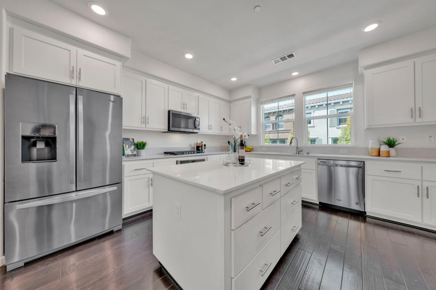 103 Cypress Loop Hayward, CA 94544 - Photo 16 of 55 a kitchen with white cabinets and white appliances