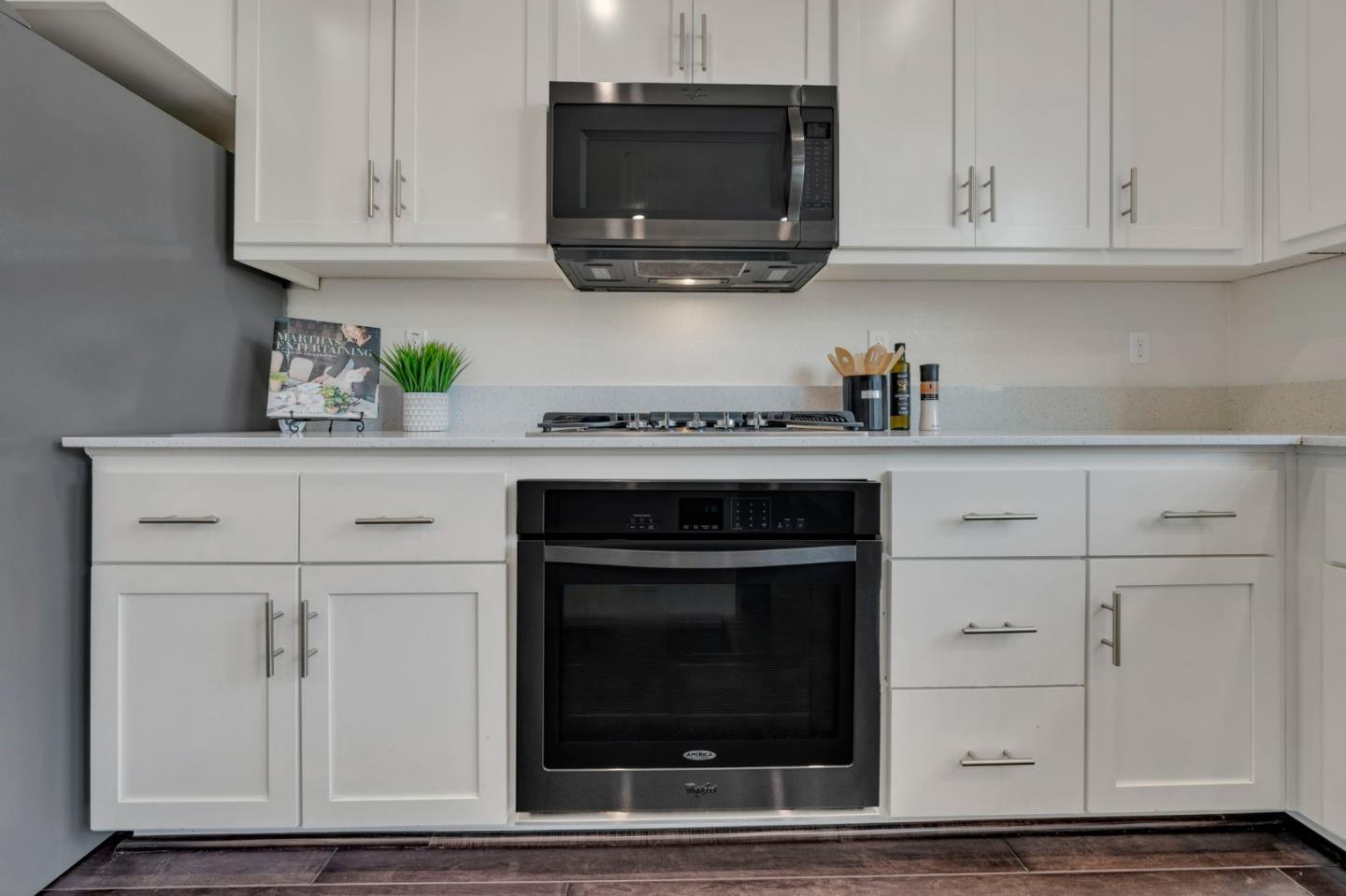 103 Cypress Loop Hayward, CA 94544 - Photo 18 of 55 a kitchen with white cabinets and stainless steel appliances