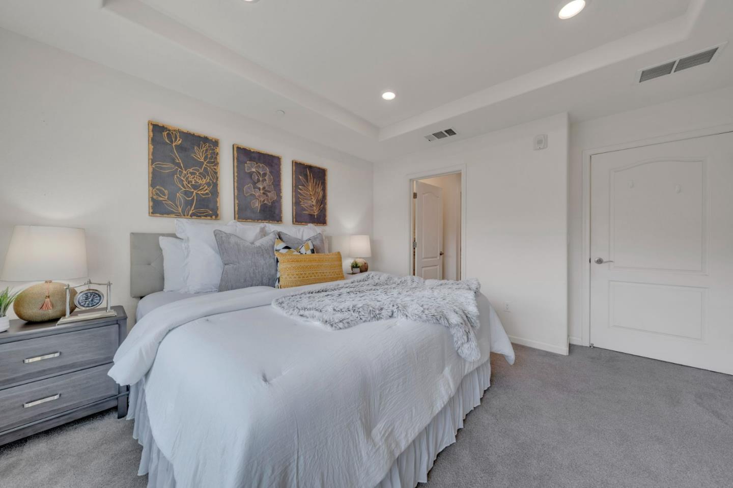 103 Cypress Loop Hayward, CA 94544 - Photo 26 of 55 a spacious bedroom with a bed and painting on the wall