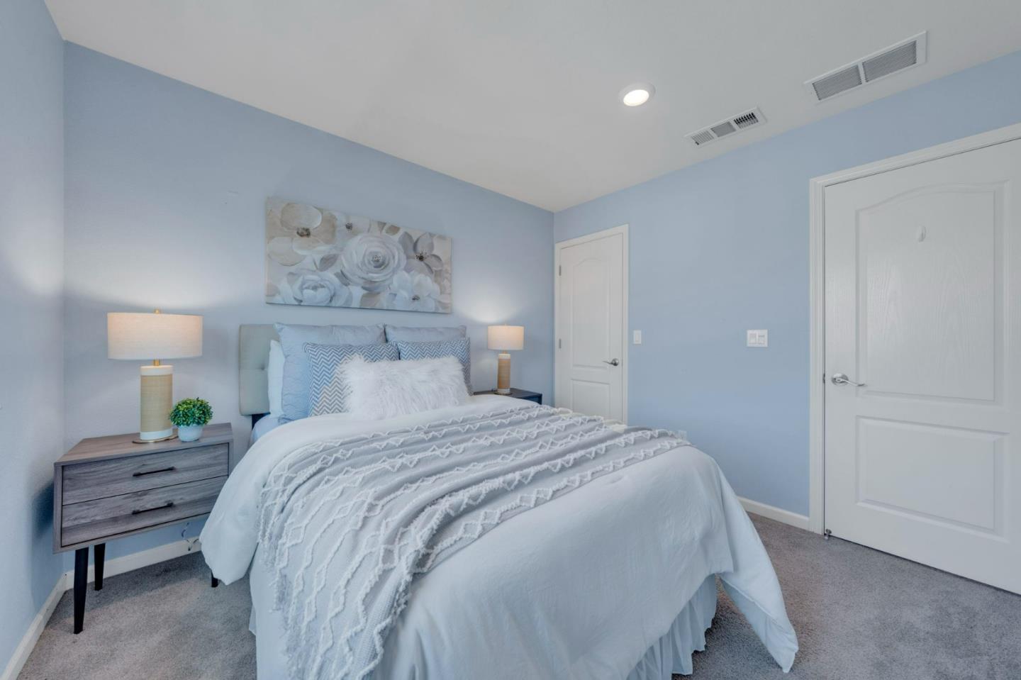 103 Cypress Loop Hayward, CA 94544 - Photo 33 of 55 a bedroom with a bed and a lamp on dresser