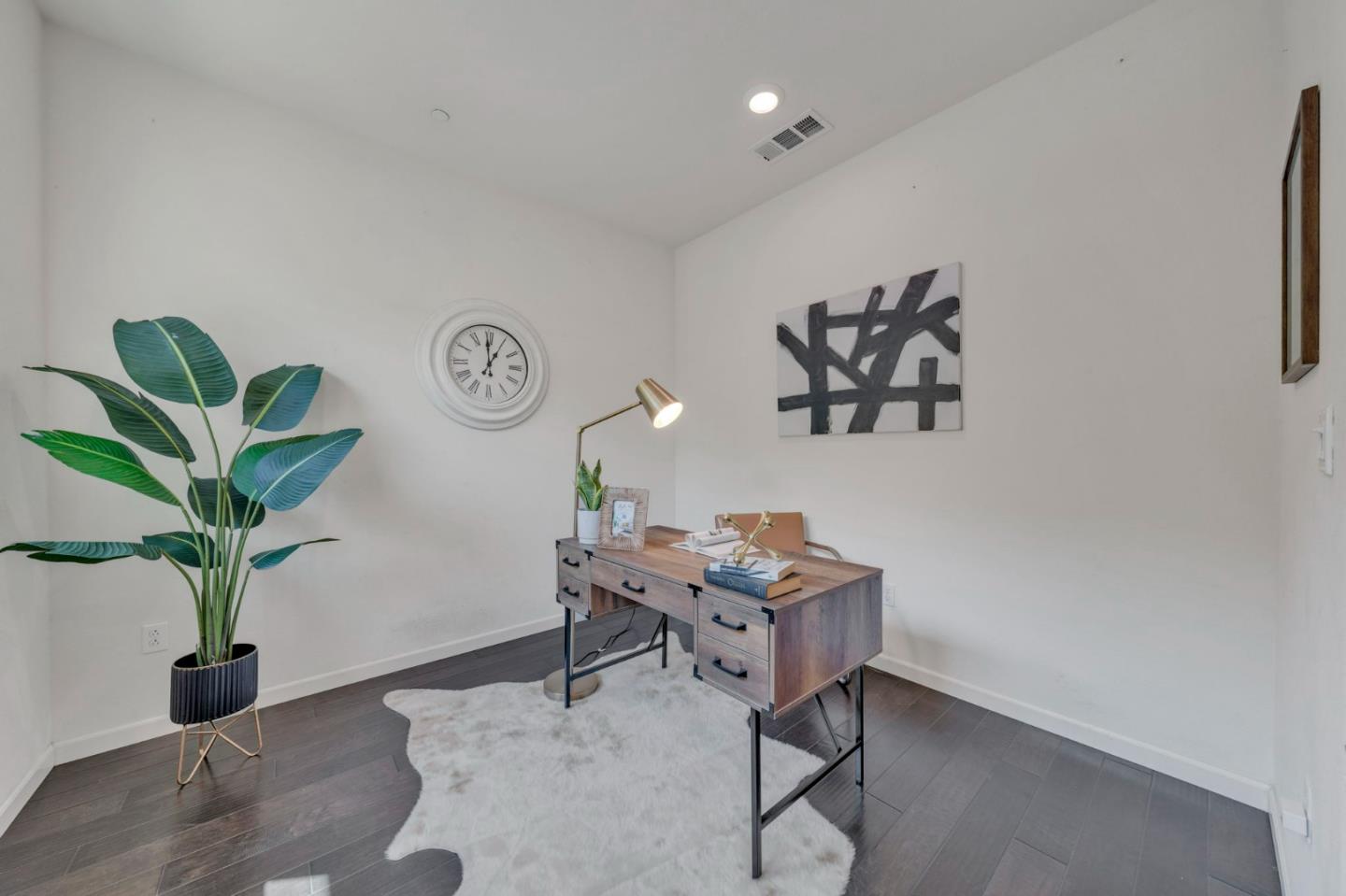 103 Cypress Loop Hayward, CA 94544 - Photo 6 of 55 a workspace with furniture and a potted plant