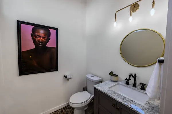 a bathroom with a toilet a sink and mirror