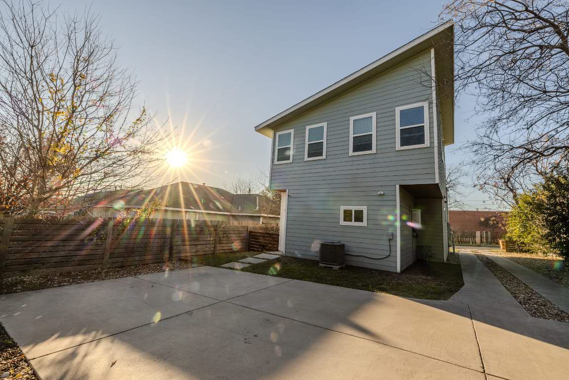 7609 Bennett Avenue, Unit A Austin, TX 78752 - Photo 19 of 20 Back of property at dusk featuring a fenced backyard and a patio area