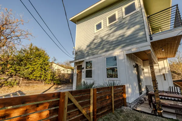 a view of a house with wooden fence