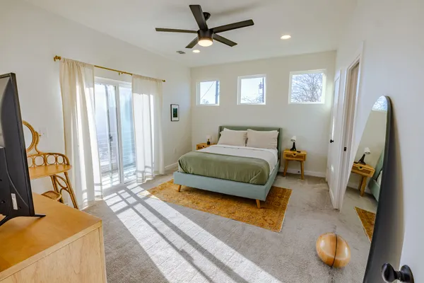 a bedroom with furniture and a flat screen tv
