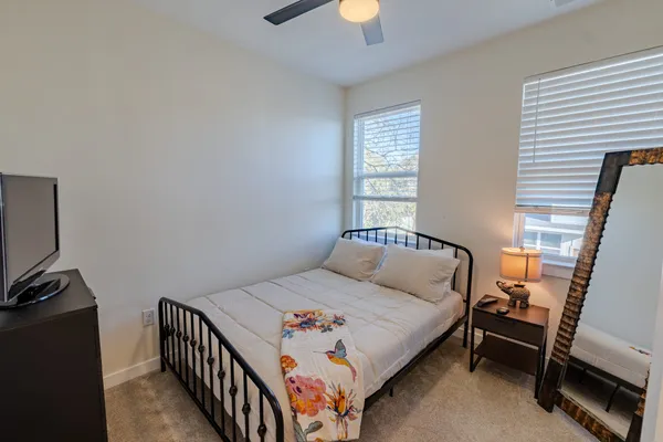 a bedroom with a bed and a tv