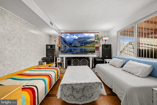 a bedroom with a bed and a television